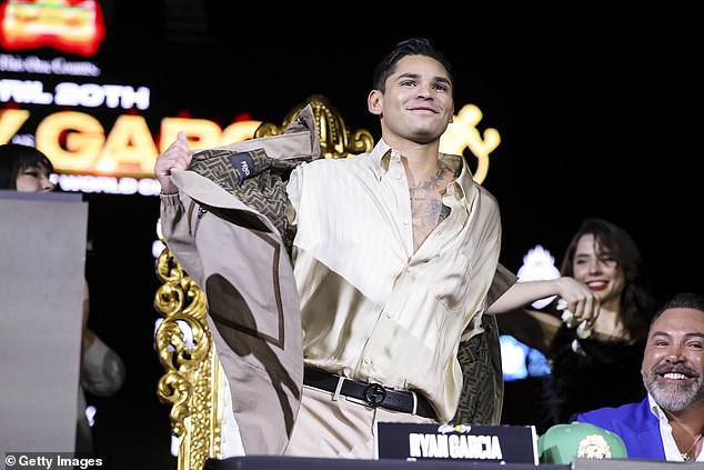 82139083-13166891-Ryan_Garcia_smiles_as_he_arrives_on_stage_for_his_press_tour_i.jpg